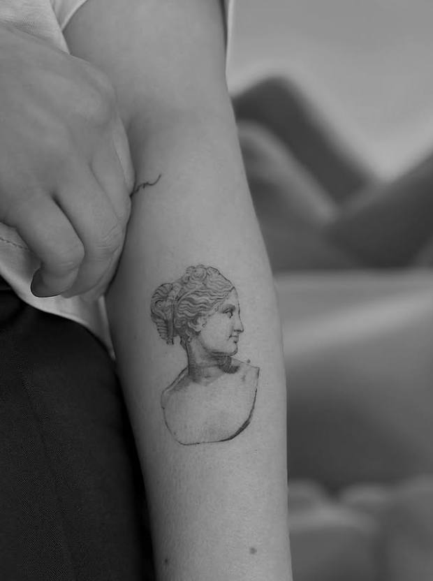 Minimal fine line forearm tattoo — classical bust tattoo Bonn
